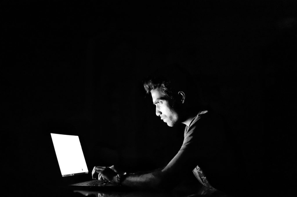 Man at Laptop in Dark room